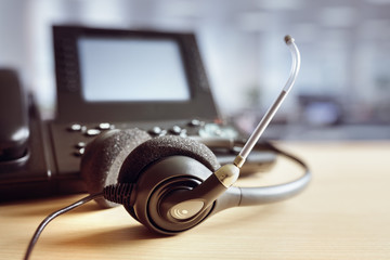 Headset headphones and telephone in call center - obrazy, fototapety, plakaty