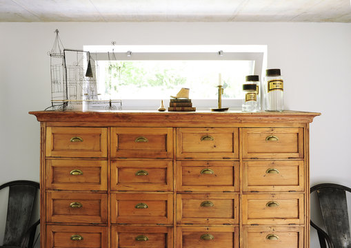 Chest of drawers or buffet in antique wood with objects of flea market and decoration