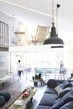 Overview of a house and its living room industrial vintage style with antiques and objects from flea markets in a trendy atmosphere