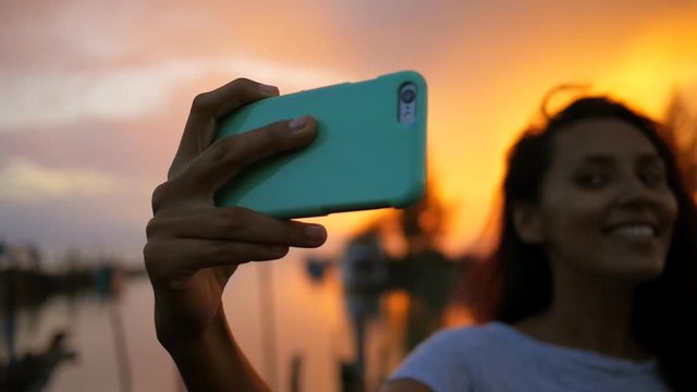 Young Mixed Race Woman Making Selfie at Beautiful Sunset. Girl Silhuette Using Mobile Phone. HD Slowmotion. Thailand.