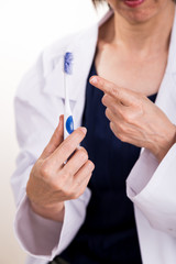 Dentist pointing at old worn out toothbrush bristle