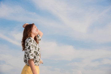 Young woman happy in summer sunlight sky outdoor. summer concept