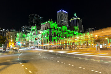 Fototapeta na wymiar Brisbane night traffic and Treasury Casino lit up green for the One Punch Kills Campaign.