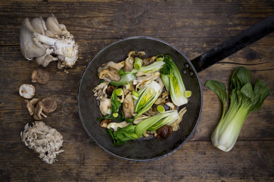 Stir-fry with Chinese cabbage, maitake, oyster and shitake mushrooms in pan
