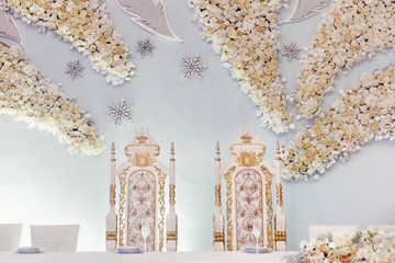 luxury decorated centerpiece for bride and groom with hydrangea and roses at rich wedding reception. golden stylish arrangements of flowers and jewels, expensive catering. space for text