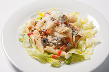 Pasta. Penne Pasta with Bolognese Sauce, Parmesan Cheese and lettice. Italian Cuisine. Mediterranean food