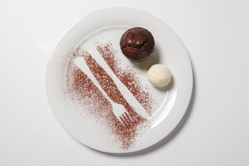 Lava cake with ice cream on a white plate.