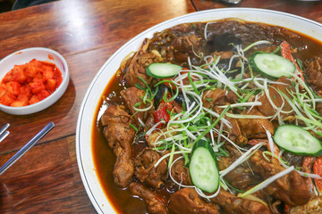 Korean food braised chicken with vegetables and kimchi close-up on the table.