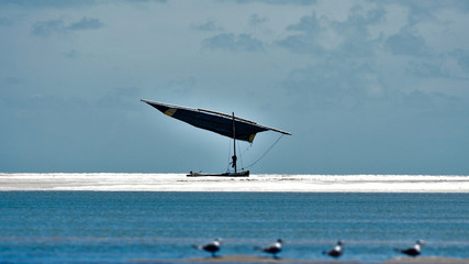 Fototapeta na wymiar Fishing boat with shiny ocean