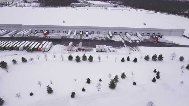 Aerial wide shot of warehouse snow