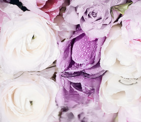 soft  pink roses  and  tulips on the shiny surface of the sparkling drops. a beautiful reflection surface. Vintage style
