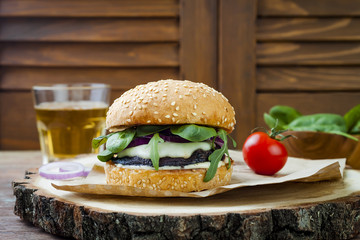 Grilled portobello mushroom burger. Healthy veggies hamburger with onions, arugula, cheese, spicy pickled hot peppers and tartar sauce. Copy space background