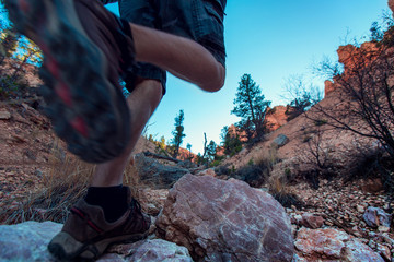 Hiker crossing rocky terrain in the Bryce Canyon National Park, USA