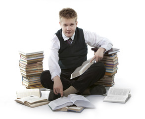 Teenager schoolboy with pile of textbooks