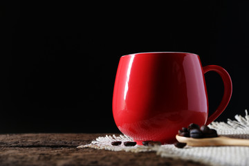 Red coffee cup on the table in studio