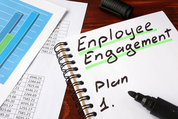 Employee engagement written in a notebook and marker.