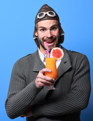 bearded pilot with cocktail in glass