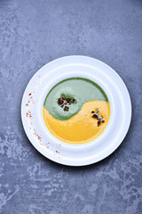 spinach and pumpkin cream soup or puree in infinity sign