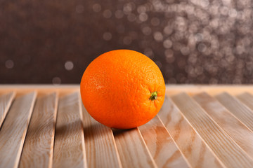 fresh orange on brown wooden table, sparkling background