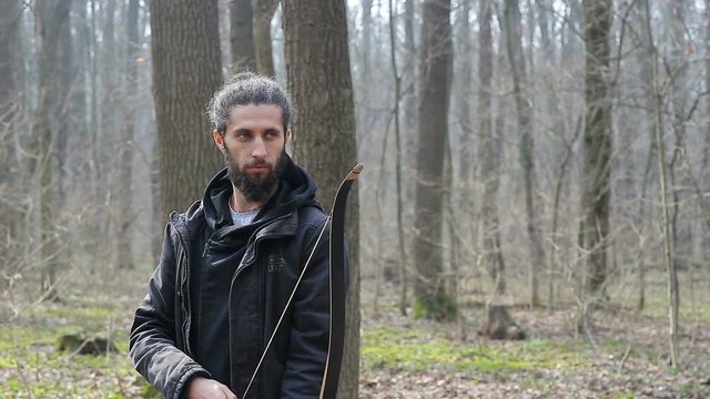Man shoot with a bow in the forest