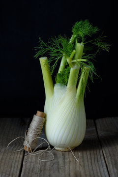 Fresh fennel bulb on wooden table. Close up fresh organic vegetables.