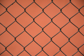 wire mesh steel , fence with orange background