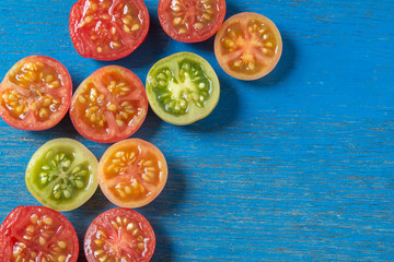 Fresh tomatoes on colored wood