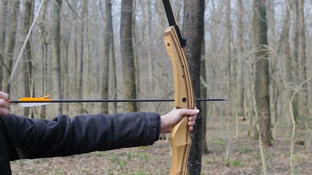 Man shoot with a bow in the forest