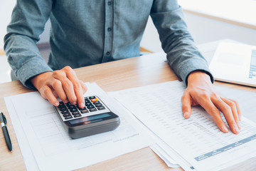 Accountant calculating income and examining report