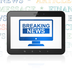 News concept: Tablet Computer with Breaking News On Screen on display