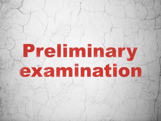 Education concept: Preliminary Examination on wall background