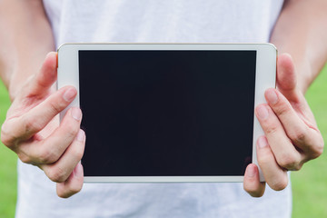 handsome man hold a tablet with a black screen, close up a tablet