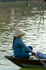 Foto op Canvas The boatwoman  on the old national vietnamese boat © Netfalls