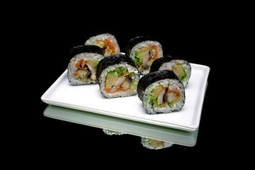 Rolls with eels and avocado on a white plate.