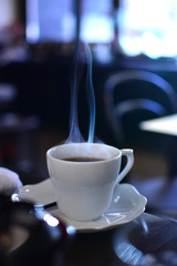 Steam rising up from white coffee cup