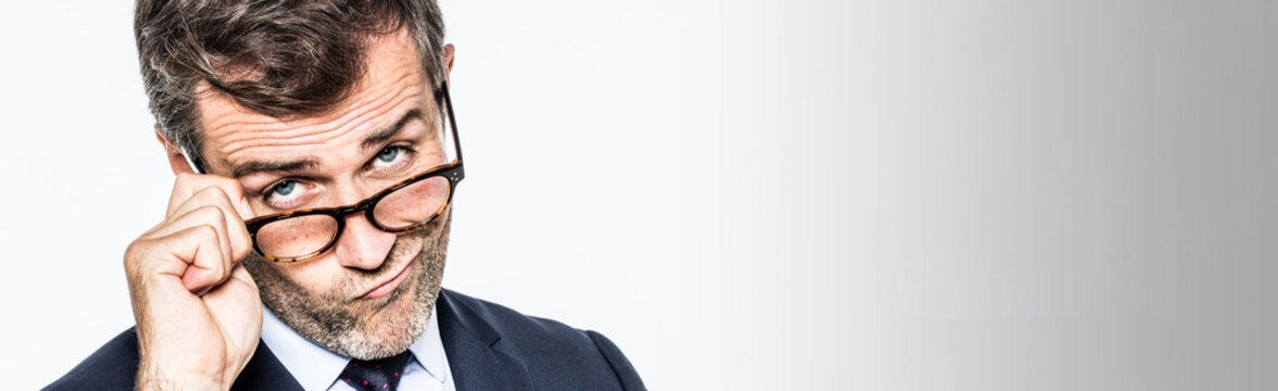 long banner for pouting far-sighted businessman moving eyeglasses down