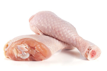 Two raw chicken drumsticks isolated on white background