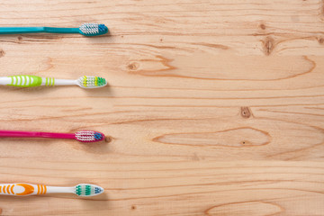 toothbrushes on the light wooden background with copy space for your text. Top view