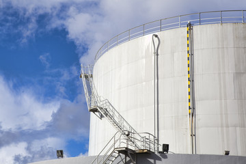 White tanks in tank farm with iron staircase