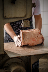 Butcher is slicing meat