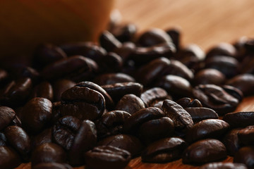 Roasted coffee beans espresso with a wood background