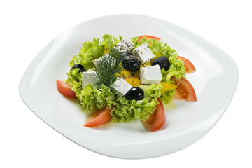 Greek salad on a plate on a white background