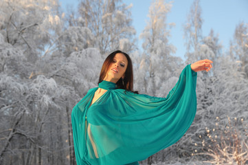 Girl dancing on the background of a winter landscape.