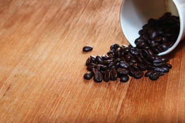 Roasted coffee beans with a wood  background