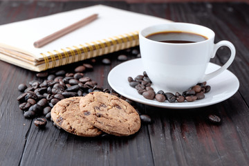 Coffee cup and coffee beans on wooden background