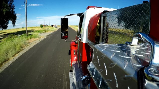 View from side of fire truck driving down highway and pulling into driveway