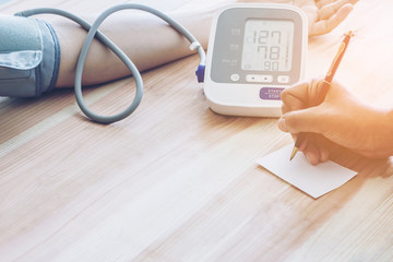Doctor cardiologist measuring blood pressure of male patient