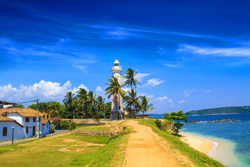 Beautiful view of the famous lighthouse in Fort Galle, Sri Lanka, on a sunny day - obrazy, fototapety, plakaty