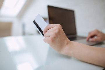 Close up and part of human hand holding credit card