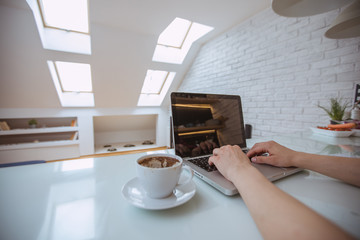 Close up and part of human hand using laptop at home